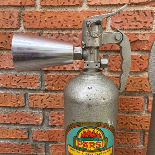 Extintor gris metálico vintage de época usado como atrezo en escenarios, pasillos o backstage.